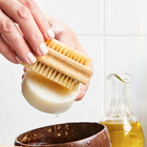 Natural vegetable fibred nail brush being used in the bathroom